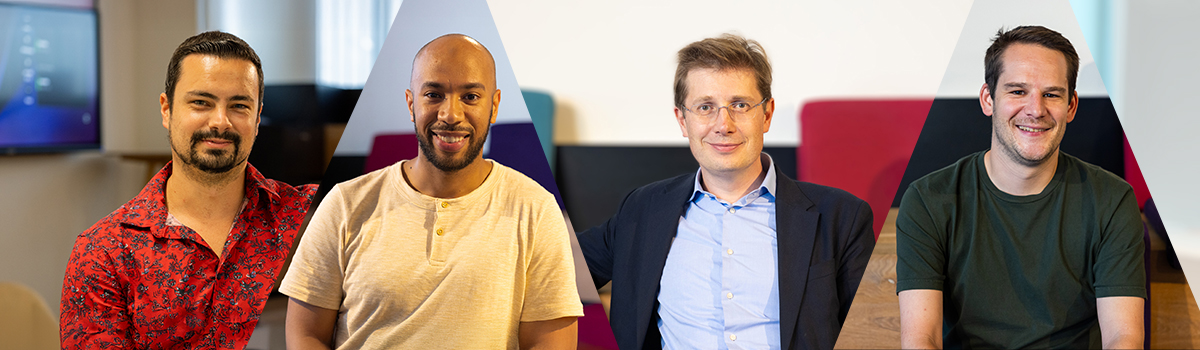 Young Asian Female Software Developer Working On Computer Together With other colleagues.